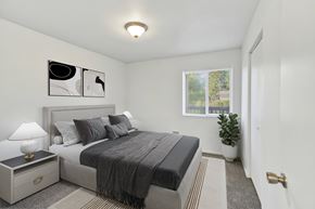 Kent apartment for rent - A bedroom with a bed, nightstand, and lamp.