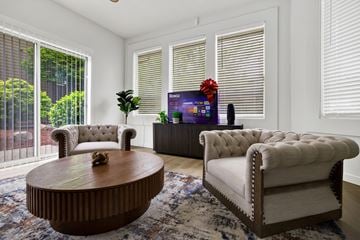 Seattle apartment for rent - A living room with a brown coffee table and two white chairs.