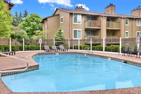 Seattle apartment for rent - A small pool in front of a building with a fence around it.