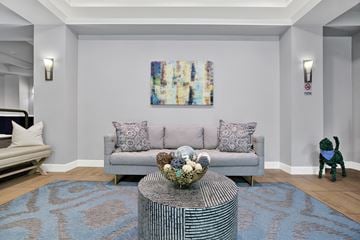 Redmond apartment for rent - A living room with a grey couch, a coffee table, and a painting on the wall.