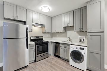 Los Angeles apartment for rent - A modern kitchen with a stainless steel refrigerator and a white dishwasher.