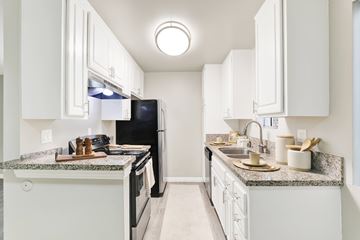Los Angeles apartment for rent - A kitchen with white cabinets and granite countertops.