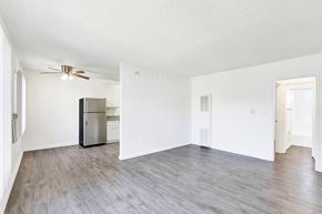 Van Nuys apartment for rent - A spacious room with a refrigerator and a ceiling fan at Sylvan Gardens,Van Nuys,California