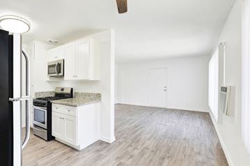 Van Nuys apartment for rent - A kitchen with white cabinets and a black refrigerator.