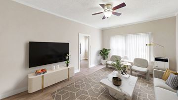 Los Angeles apartment for rent - A living room with a television, a couch, a chair, a table, and a plant.