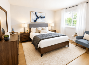 Seattle apartment for rent - A bedroom with a large bed, a nightstand, a chair, and a painting on the wall.