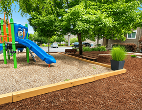 Seattle apartment for rent - A playground with a blue slide and a green climbing frame.