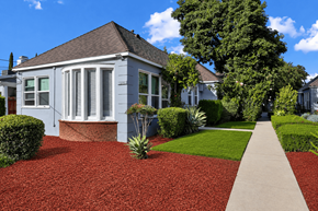 Van Nuys apartment for rent - A house with a red gravel driveway and a concrete walkway.