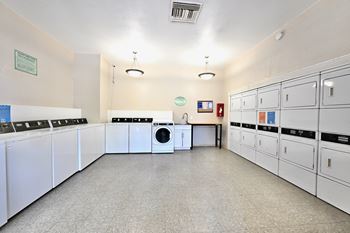 A laundry room with washers and dryers.