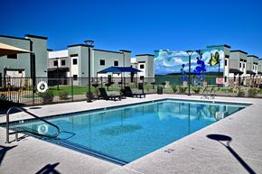 Camp Verde apartment for rent - A swimming pool in front of a building with a mural on the wall.