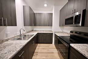 Camp Verde apartment for rent - A modern kitchen with dark wood cabinets and granite countertops.