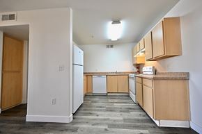 Mesa apartment for rent - A kitchen with white walls and wooden cabinets.