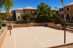 Chandler apartment for rent - A basketball court is surrounded by houses and trees.