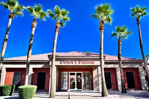 Mesa apartment for rent - A building with a red roof and a sign that says DESERT PALMS