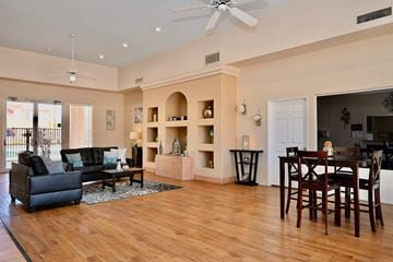 Mesa apartment for rent - A living room with a black couch and a wooden floor.