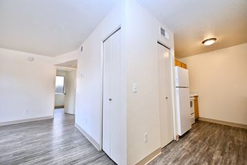 Sierra Vista apartment for rent - A kitchen area with a white fridge and a white door.