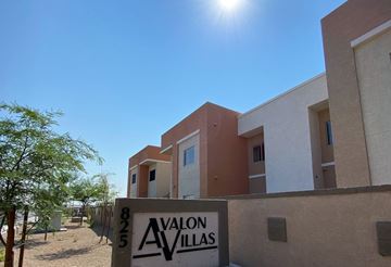 Phoenix apartment for rent - A building with a sign that says "AVALON VILLAS" in front of it.