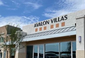 Phoenix apartment for rent - Avalon Villas building with a clear blue sky in the background.