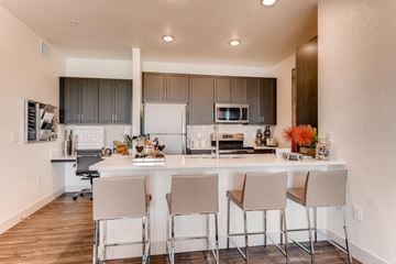Castle Rock apartment for rent - A kitchen with a white counter and chairs.