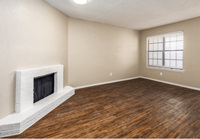 Wichita Falls apartment for rent - A room with a fireplace and wooden floors.