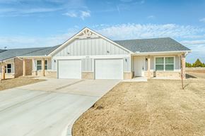 Oklahoma City triplex for rent - A two-story house with a garage and a driveway.