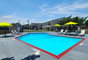 Wichita Falls apartment for rent - A large swimming pool with a red and white border.