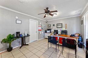 Wichita Falls apartment for rent - A room with a ceiling fan and a desk with a computer.