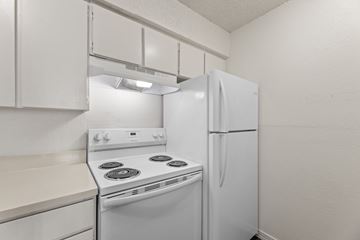 Wichita Falls apartment for rent - A white kitchen with a stove and refrigerator.