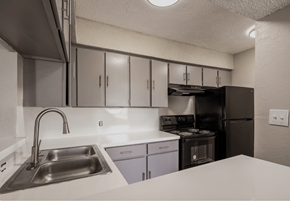 Wichita Falls apartment for rent - A kitchen with a stainless steel sink and white countertop.