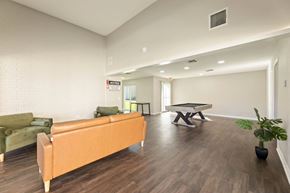 Wichita Falls apartment for rent - A living room with a sofa, a coffee table, and a plant.