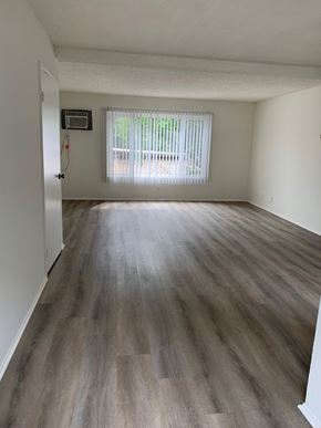 North Hills apartment for rent - an empty living room with wood flooring and a window