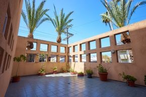Los Angeles apartment for rent - A courtyard with a tiled floor and potted plants.