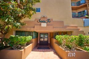 Los Angeles apartment for rent - The Santa Fe building has a brown sign and a black door.