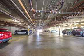 Los Angeles apartment for rent - A parking garage with cars parked on the ground floor.