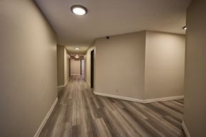 Los Angeles apartment for rent - A long hallway with wood flooring and white walls.