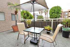 Los Angeles apartment for rent - A patio with a table, chairs and an umbrella.