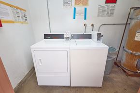 Los Angeles apartment for rent - A white appliance with a black top sits in a room with a warning sign on the wall.