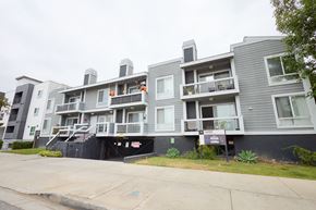 Van Nuys apartment for rent - Apartment building with a black gate in front.