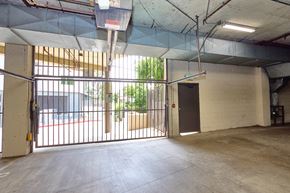 Los Angeles apartment for rent - A large, empty garage with a basketball hoop and a basketball on the ground.