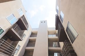 Los Angeles apartment for rent - A view of a building looking up at the sky.