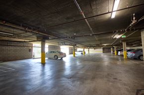 Los Angeles apartment for rent - A parking garage with a white car parked in the middle.