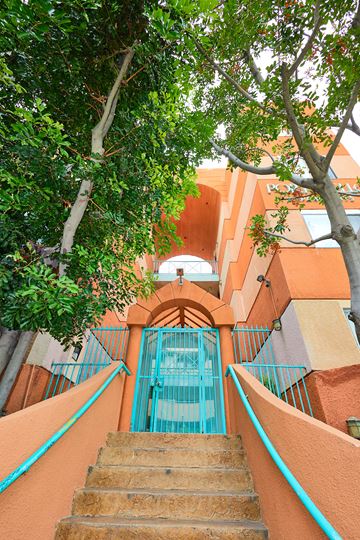 Los Angeles apartment for rent - A staircase with a blue railing leads to a pool.