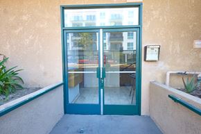 Los Angeles apartment for rent - A green double door with a glass window and a metal handle.