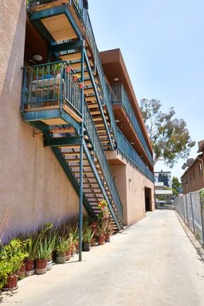 Los Angeles apartment for rent - A staircase with a metal railing and steps leading up to a balcony.