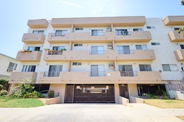 Los Angeles apartment for rent - A large apartment building with a black gate in front.