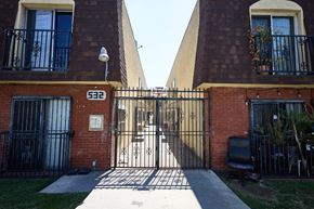 Los Angeles apartment for rent - A black gate with the number 622 on it is in front of a brick building.
