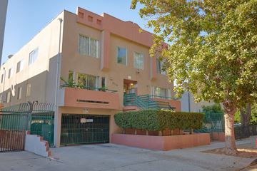Los Angeles apartment for rent - A modern two-story building with a green gate and a tree in front.