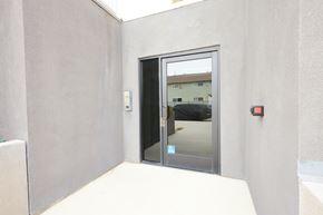 North Hollywood apartment for rent - A glass door with a handle is in the middle of a white wall.