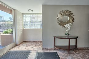 Los Angeles apartment for rent - A room with a round table and a wall art.