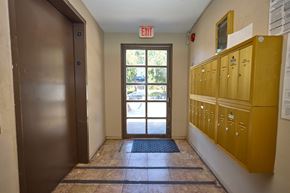 Los Angeles apartment for rent - A hallway with a brown door and yellow lockers.